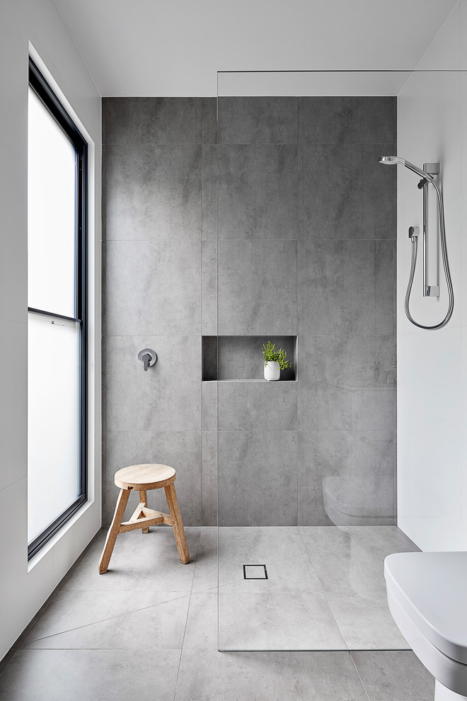 Inspiration for a small contemporary master bathroom in Melbourne with furniture-like cabinets, white cabinets, an open shower, a wall-mount toilet, gray tile, ceramic tile, white walls, ceramic floors, an undermount sink, engineered quartz benchtops, grey floor, an open shower, grey benchtops, a shower seat, a single vanity and a floating vanity.