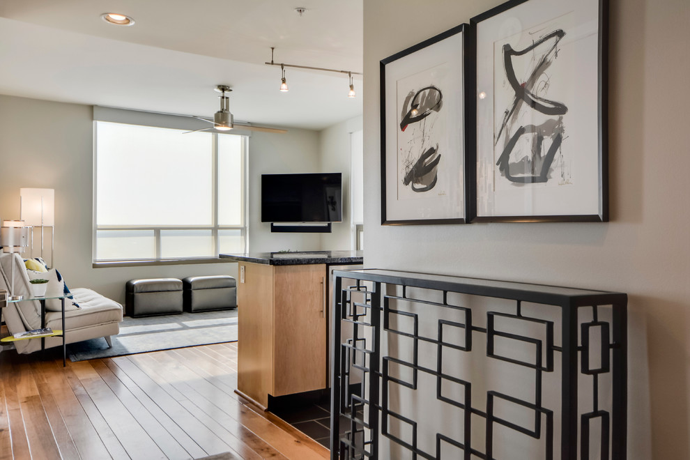 Small transitional light wood floor foyer photo in Austin with gray walls and a light wood front door