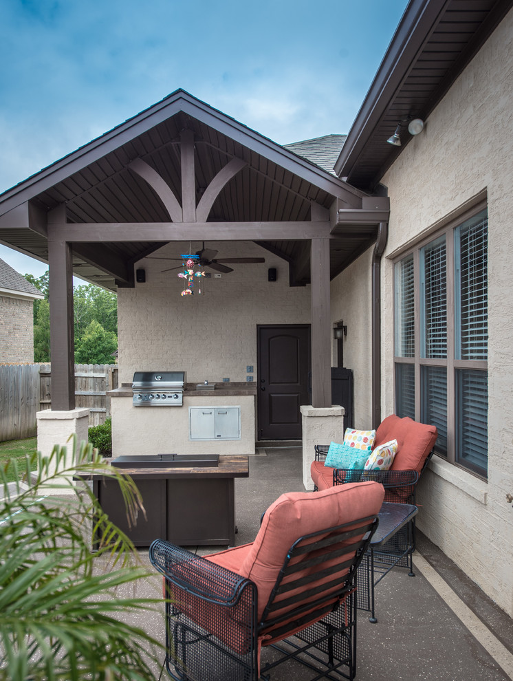 Mid-sized traditional backyard patio in Little Rock with an outdoor kitchen, concrete slab and a roof extension.