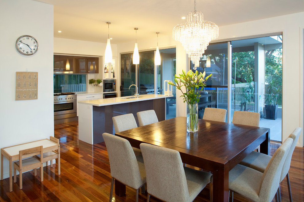 Inspiration for a mid-sized traditional dining room in Brisbane with white walls and dark hardwood floors.