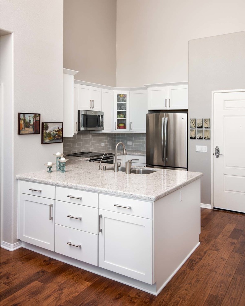 Small transitional u-shaped kitchen pantry in San Diego with an undermount sink, shaker cabinets, white cabinets, quartz benchtops, grey splashback, subway tile splashback, stainless steel appliances, porcelain floors and a peninsula.