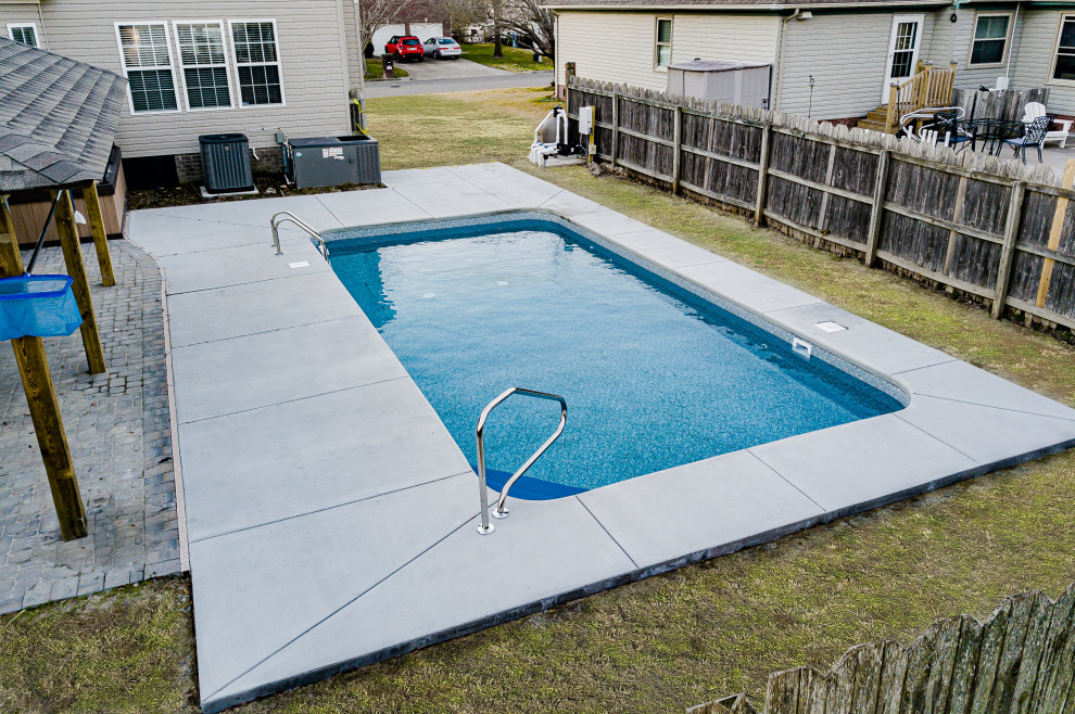 Design ideas for a large modern backyard rectangular lap pool in Other with with a pool and concrete slab.
