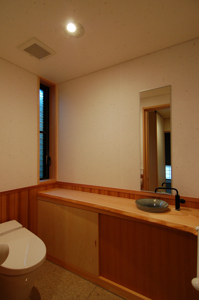 Photo of an asian powder room in Other with white walls, marble floors, wood benchtops and white floor.