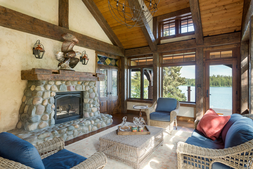 Photo of a mid-sized country sunroom in Jackson with medium hardwood floors, a standard fireplace, a stone fireplace surround, brown floor and a standard ceiling.