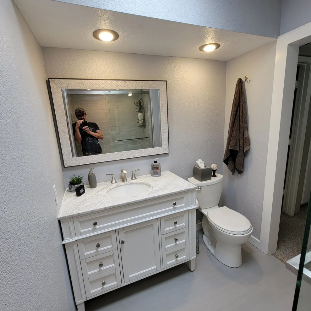 Photo of a small contemporary master bathroom in Phoenix with furniture-like cabinets, dark wood cabinets, an alcove tub, a shower/bathtub combo, a two-piece toilet, beige walls, travertine floors, an undermount sink, granite benchtops, orange floor, a shower curtain, beige benchtops, a single vanity and a freestanding vanity.