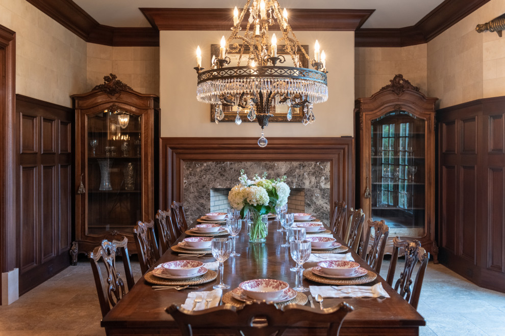 Enclosed dining room - large french country travertine floor, beige floor and wainscoting enclosed dining room idea in Atlanta with beige walls, a standard fireplace and a wood fireplace surround