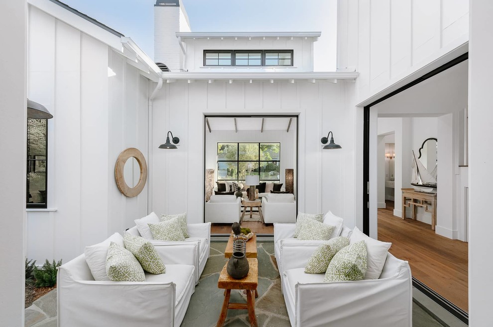 Country courtyard patio in Los Angeles with tile and no cover.