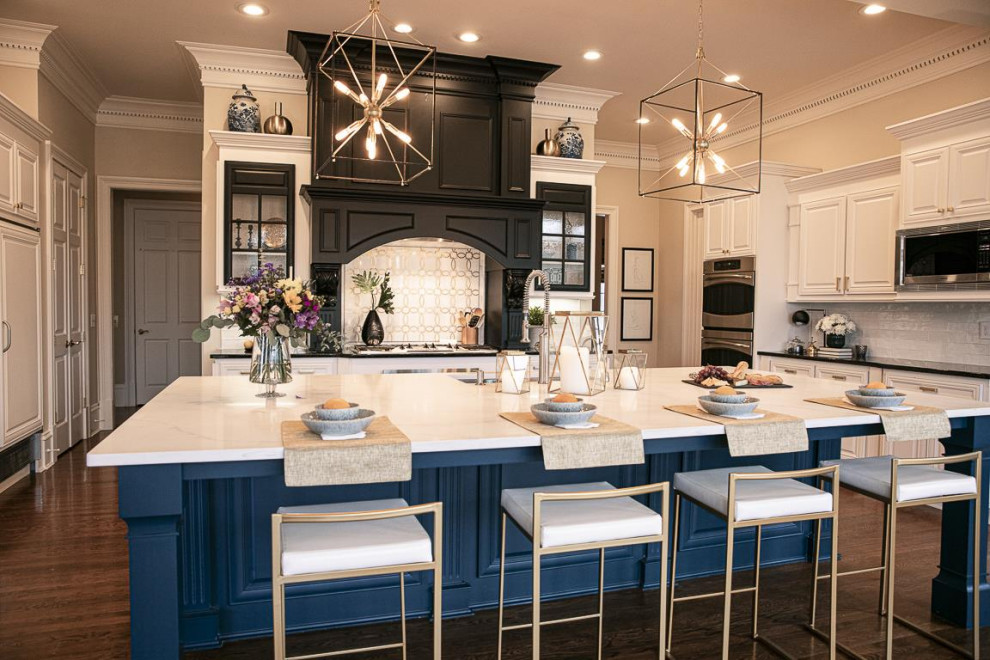 Photo of a large transitional u-shaped eat-in kitchen in Atlanta with a double-bowl sink, raised-panel cabinets, white cabinets, quartz benchtops, white splashback, marble splashback, panelled appliances, dark hardwood floors, with island, white floor and white benchtop.