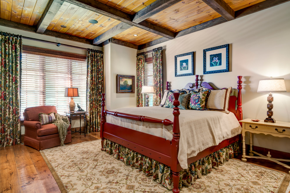 Photo of a traditional master bedroom in Charlotte with light hardwood floors.