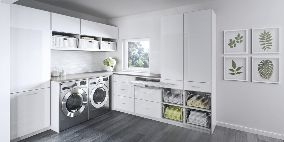 Inspiration for a large contemporary l-shaped dedicated laundry room in Nashville with white cabinets, white walls, a side-by-side washer and dryer, flat-panel cabinets, laminate benchtops and linoleum floors.