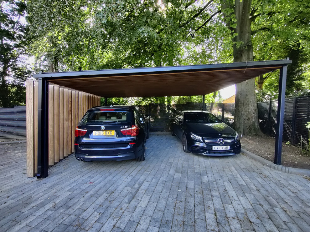 This is an example of a large modern detached double carport in Other.