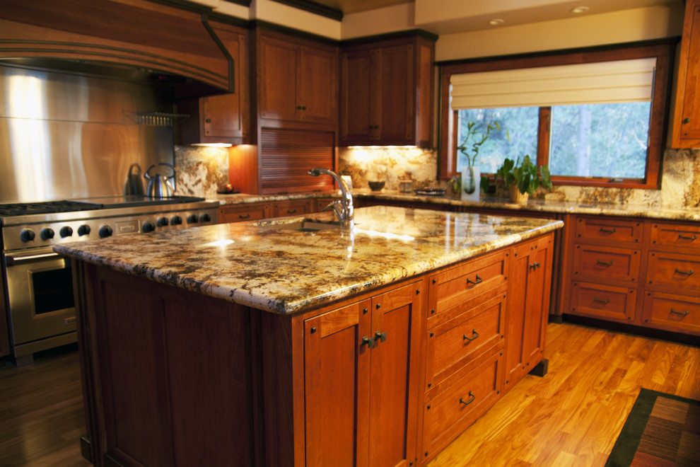 Design ideas for an expansive arts and crafts u-shaped eat-in kitchen in Sacramento with an undermount sink, shaker cabinets, medium wood cabinets, granite benchtops, stainless steel appliances, medium hardwood floors and with island.