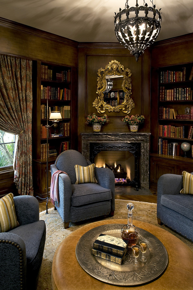 This is an example of a traditional family room in Orange County with a corner fireplace and a library.