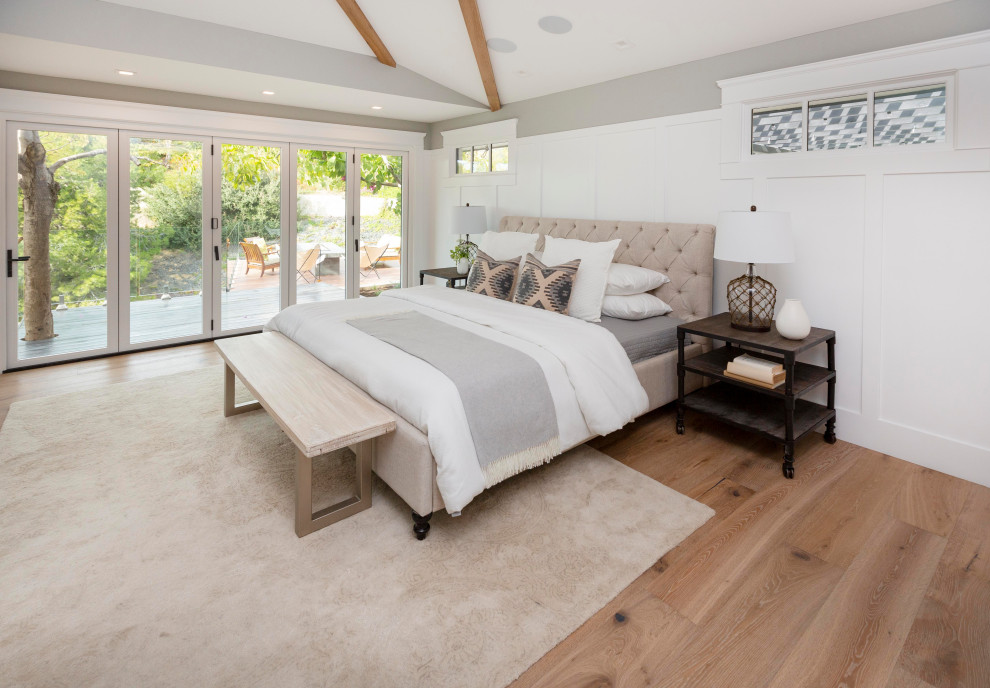 Inspiration for a large modern master bedroom in San Diego with white walls, light hardwood floors and decorative wall panelling.