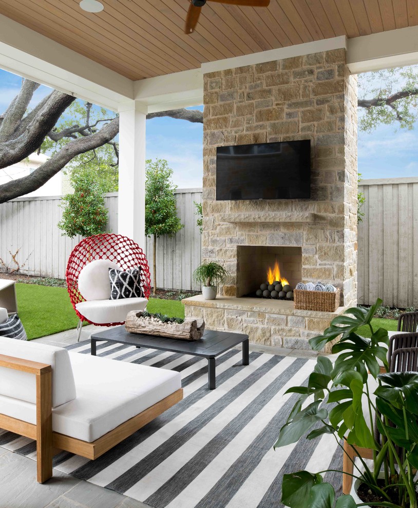 Beach style backyard patio in Dallas with with fireplace.