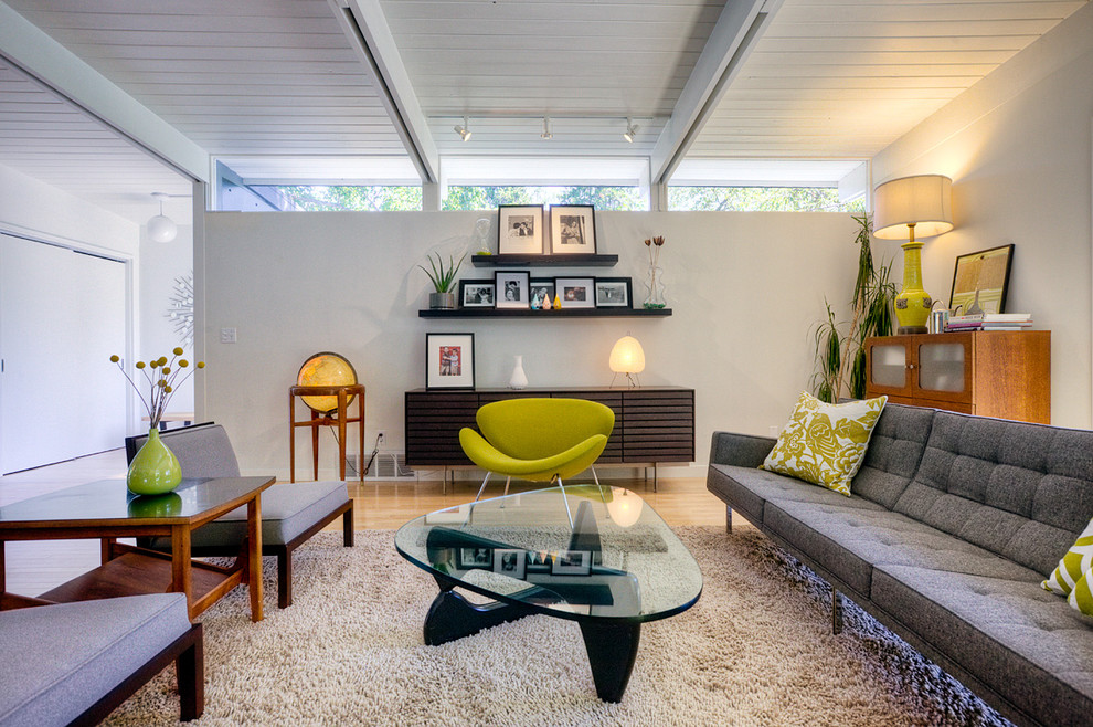Design ideas for a midcentury living room in Seattle with white walls.