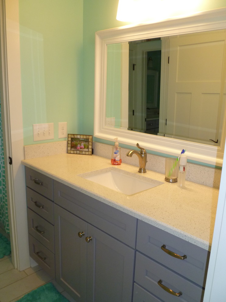 Design ideas for a mid-sized arts and crafts kids bathroom in Nashville with an undermount sink, beaded inset cabinets, medium wood cabinets, quartzite benchtops, an alcove tub, a double shower, a two-piece toilet, white tile, porcelain tile, green walls and porcelain floors.