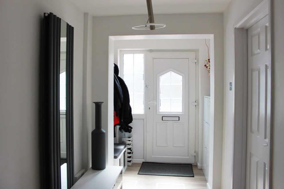 Mid-sized modern entryway in Buckinghamshire with white walls and laminate floors.