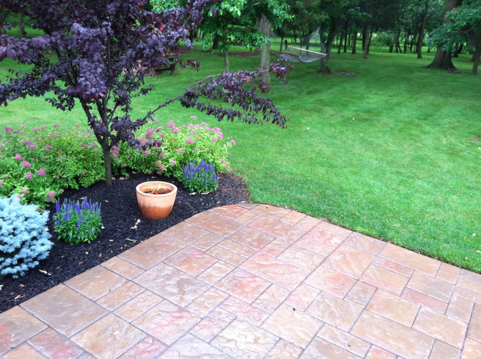 Photo of a traditional backyard patio in New York with brick pavers.