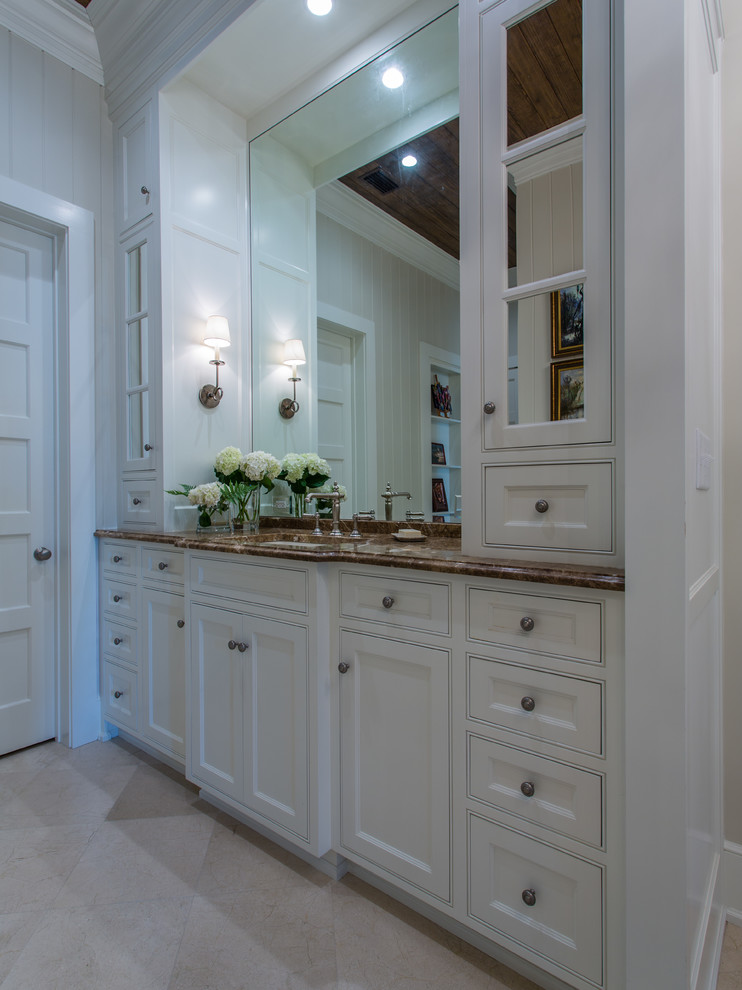 Photo of an eclectic powder room in Other with marble benchtops, porcelain tile, white walls, porcelain floors, an undermount sink, recessed-panel cabinets, white cabinets and beige floor.