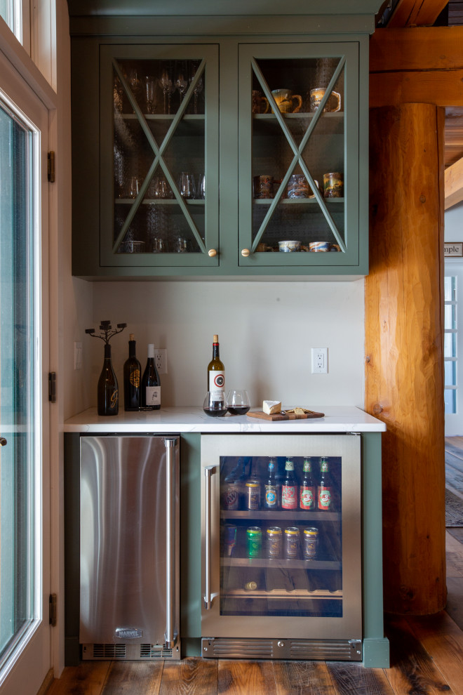 This is an example of a large country l-shaped home bar in New York with shaker cabinets, white cabinets, quartz benchtops, white splashback and subway tile splashback.