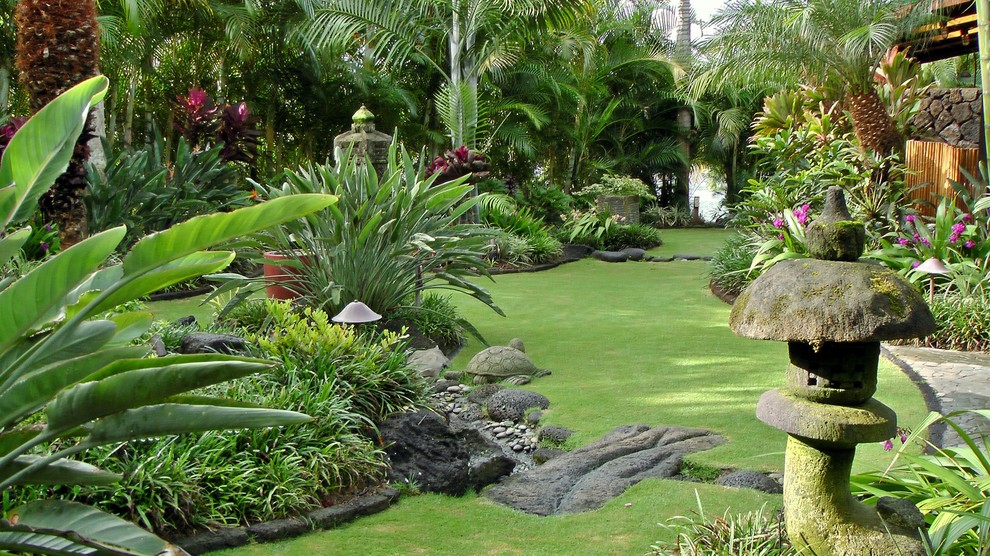 Inspiration for a mid-sized asian backyard full sun formal garden for spring in Tampa with natural stone pavers.