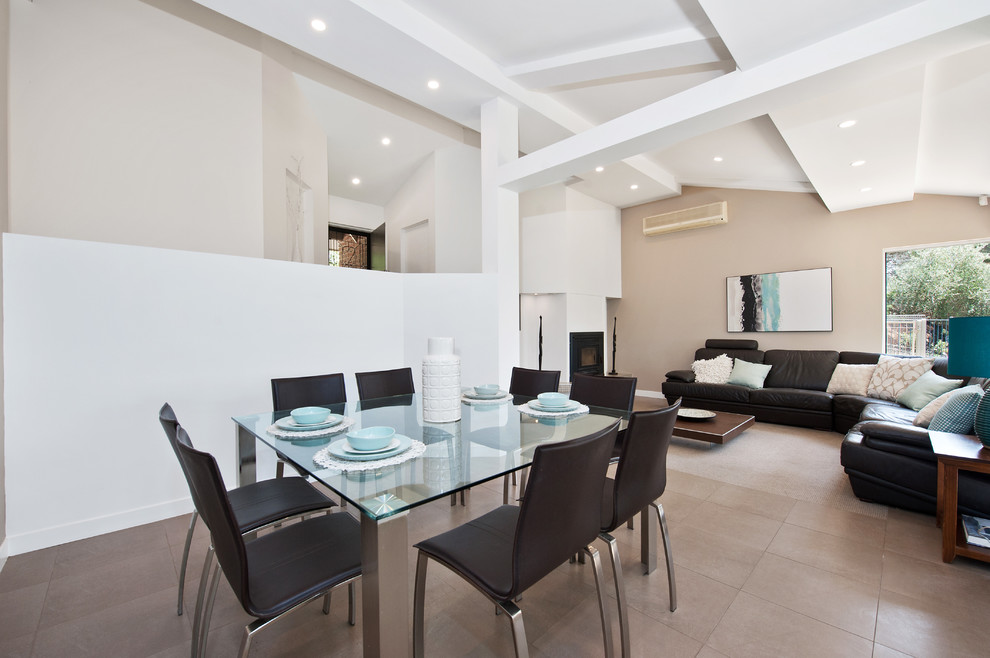This is an example of a large contemporary open concept family room in Adelaide with white walls, porcelain floors, a standard fireplace and a tile fireplace surround.