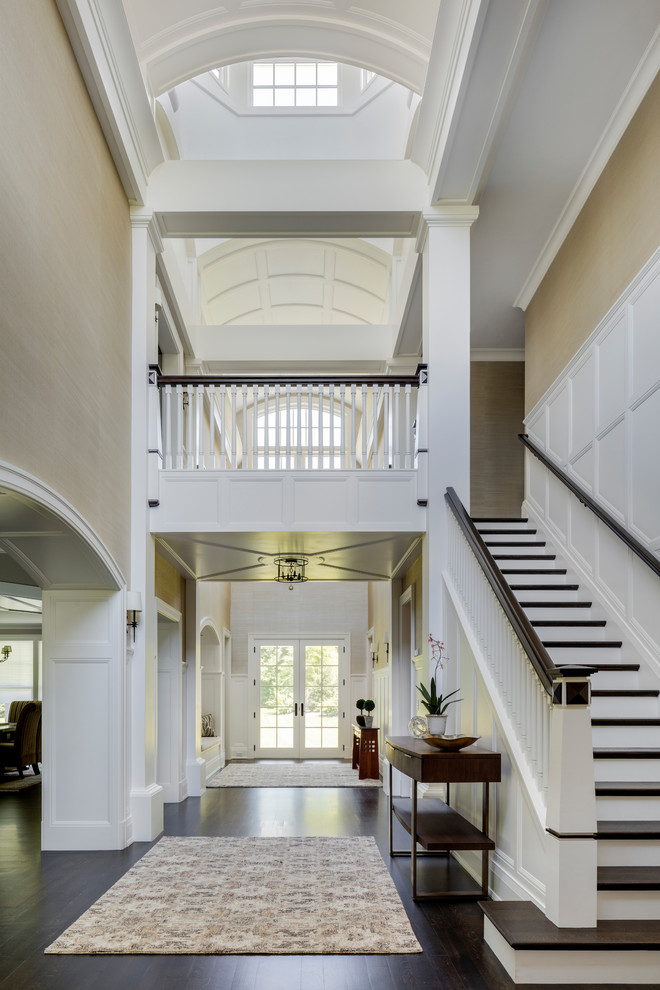 Photo of an expansive traditional wood straight staircase in Boston with painted wood risers and wood railing.