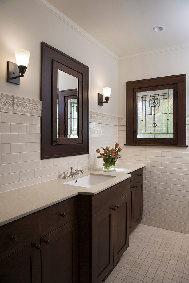 Traditional bathroom in Chicago with dark wood cabinets.