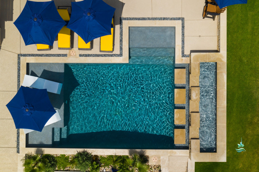 Pool landscaping - huge mediterranean backyard custom-shaped infinity pool landscaping idea in Dallas with decking