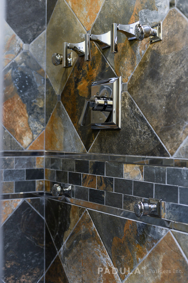 Modern bathroom in New York with multi-coloured tile and stone tile.