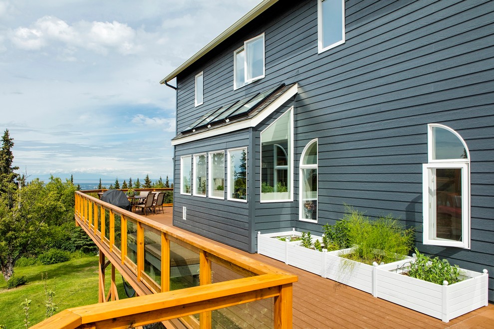 This is an example of an expansive arts and crafts side yard deck in Other with a pergola.
