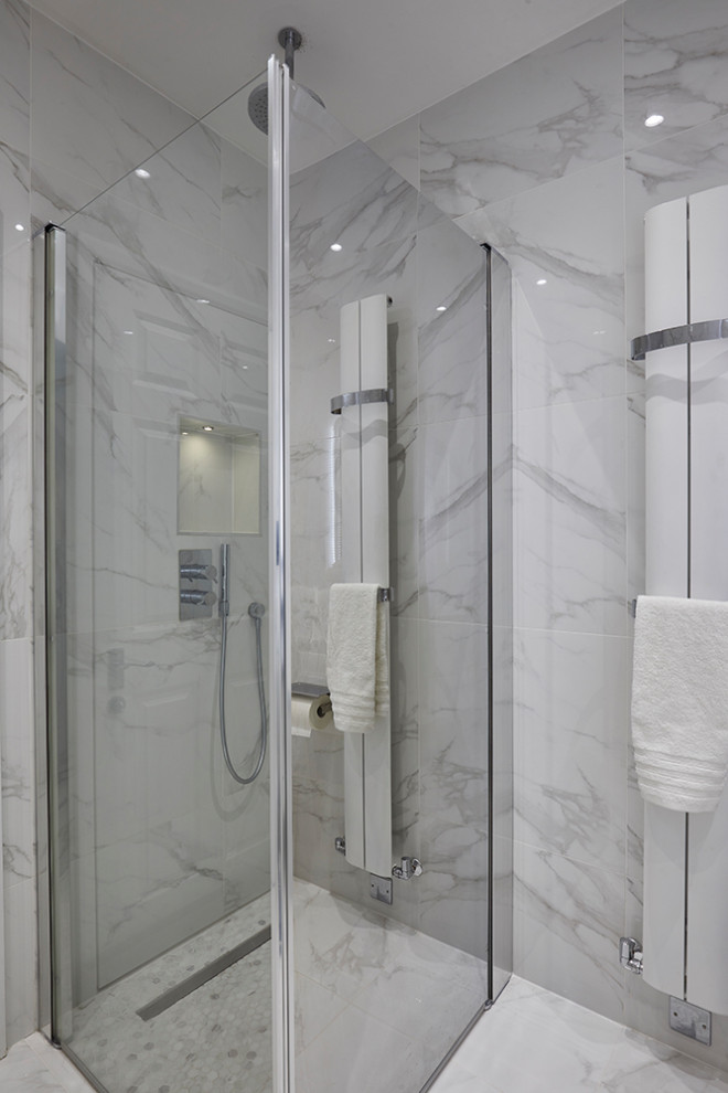 Design ideas for a mid-sized contemporary 3/4 bathroom in London with flat-panel cabinets, a corner shower, a wall-mount toilet, white tile, porcelain tile, white walls, porcelain floors, a drop-in sink, glass benchtops, white floor, a hinged shower door and white benchtops.