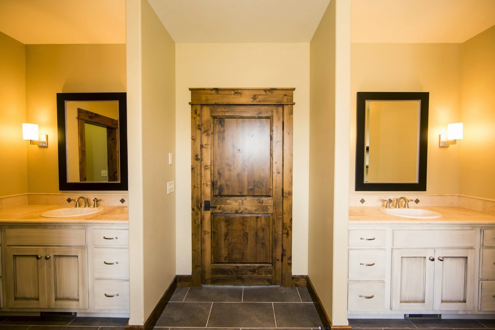 This is an example of a large traditional master bathroom in Other with shaker cabinets, light wood cabinets, an alcove tub, an alcove shower, a two-piece toilet, beige tile, stone tile, beige walls, porcelain floors, a drop-in sink, granite benchtops and grey floor.