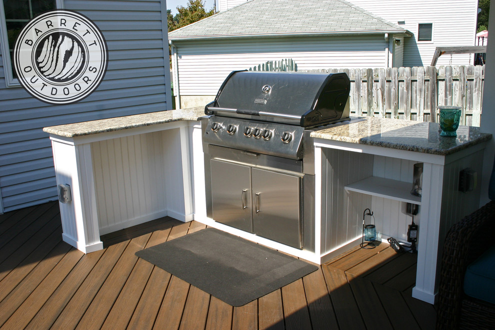 Country backyard deck in Newark with an outdoor kitchen.