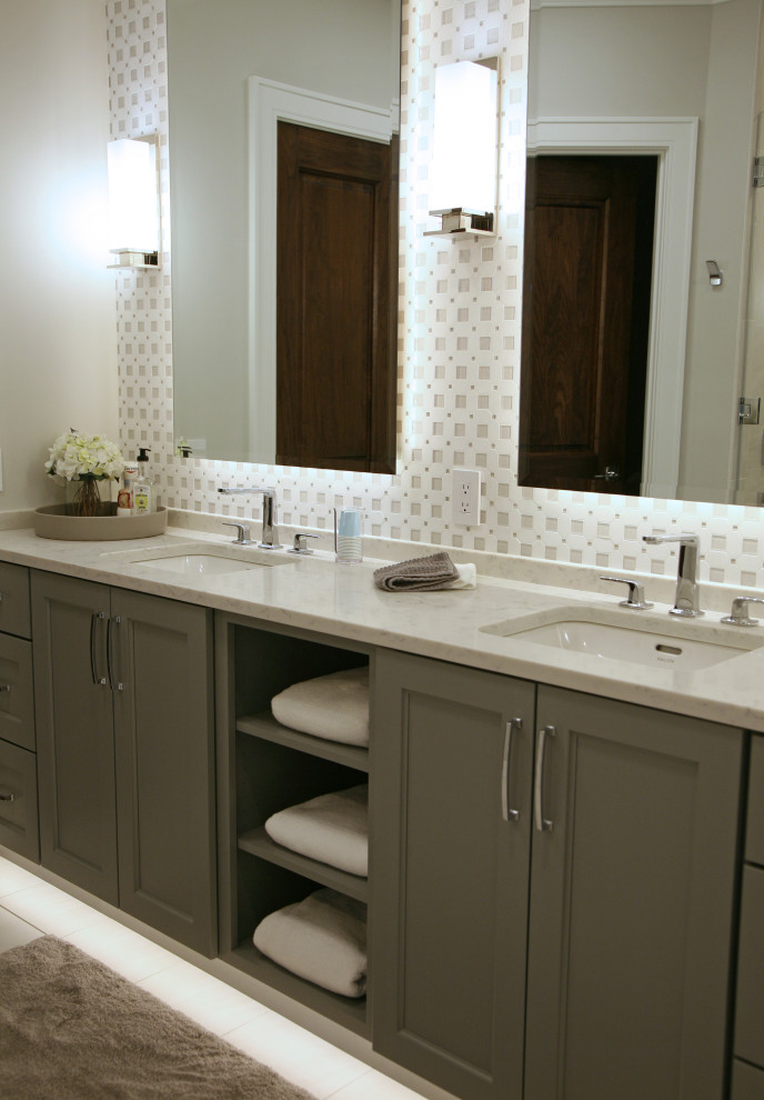 Photo of a large contemporary master bathroom in Milwaukee with flat-panel cabinets, grey cabinets, an open shower, a one-piece toilet, brown tile, glass tile, beige walls, ceramic floors, an undermount sink, engineered quartz benchtops, beige floor, a hinged shower door, white benchtops, an enclosed toilet, a double vanity and a floating vanity.