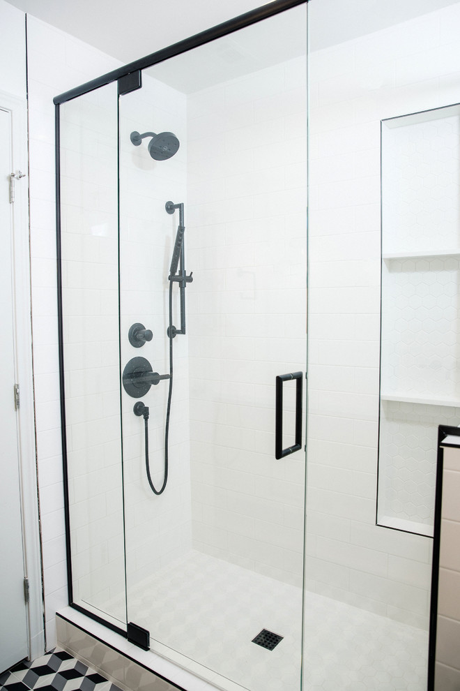 Photo of a mid-sized midcentury bathroom in Austin with flat-panel cabinets, brown cabinets, a double shower, white tile, ceramic tile, white walls, ceramic floors, a drop-in sink, engineered quartz benchtops, black floor, a hinged shower door and white benchtops.
