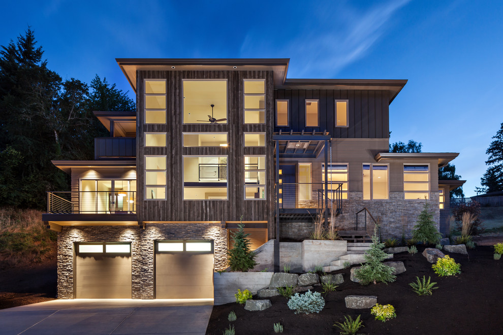 Inspiration for a large contemporary three-storey brown house exterior in Portland with mixed siding and a flat roof.