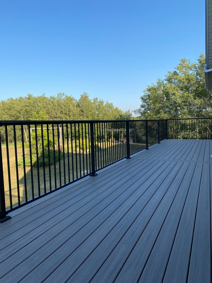 Deck - large craftsman backyard second story metal railing deck idea in Other