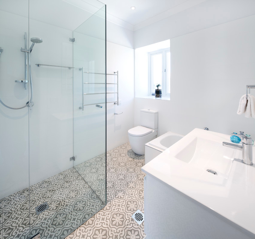 This is an example of a large transitional bathroom in Sydney with white cabinets, shaker cabinets and bamboo floors.