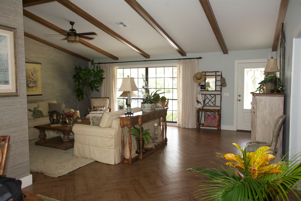 This is an example of a small beach style entryway in Miami with blue walls, dark hardwood floors, a single front door, a white front door and brown floor.