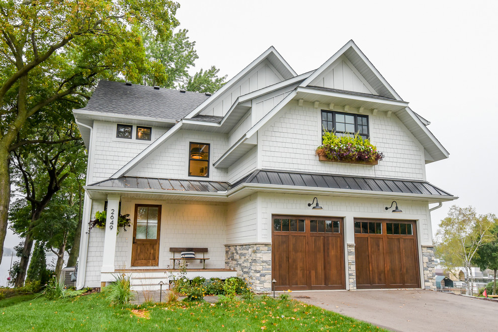 Photo of a transitional two-storey white house exterior in Minneapolis with a gable roof.