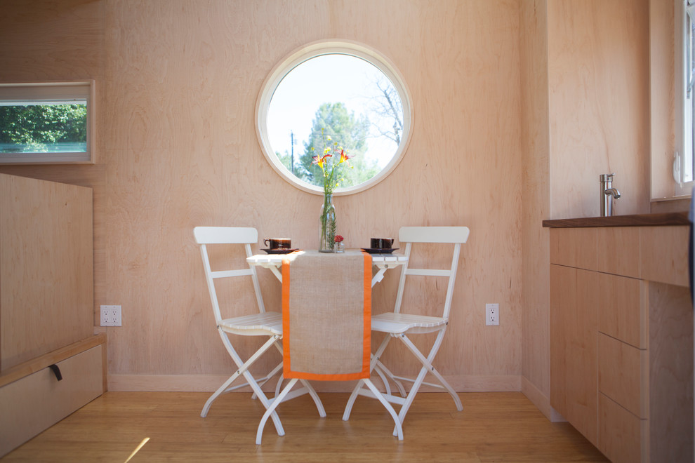 Small minimalist open concept and built-in desk light wood floor great room photo in Santa Barbara with no fireplace, no tv and white walls