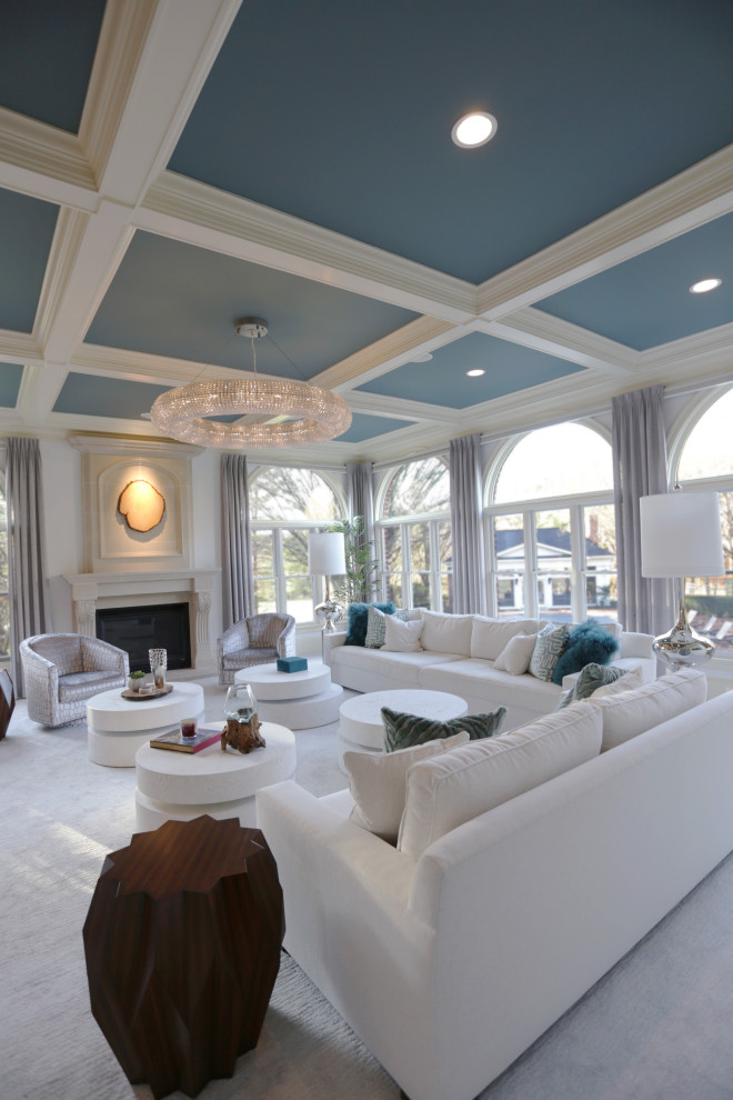 This is an example of an expansive transitional open concept living room in Las Vegas with white walls, carpet, a standard fireplace, a stone fireplace surround, a built-in media wall, grey floor and coffered.