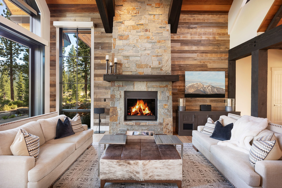 Design ideas for a large country open concept living room in Other with white walls, medium hardwood floors, a stone fireplace surround, brown floor, a wall-mounted tv and a standard fireplace.