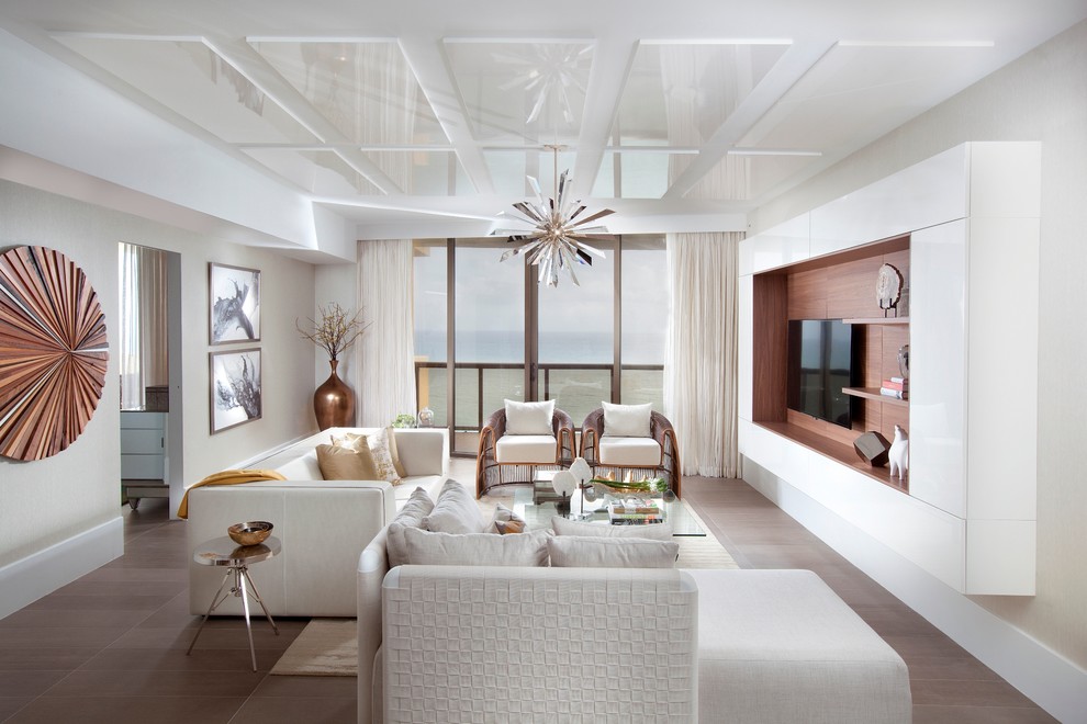 This is an example of a large contemporary living room in Miami with white walls and a wall-mounted tv.