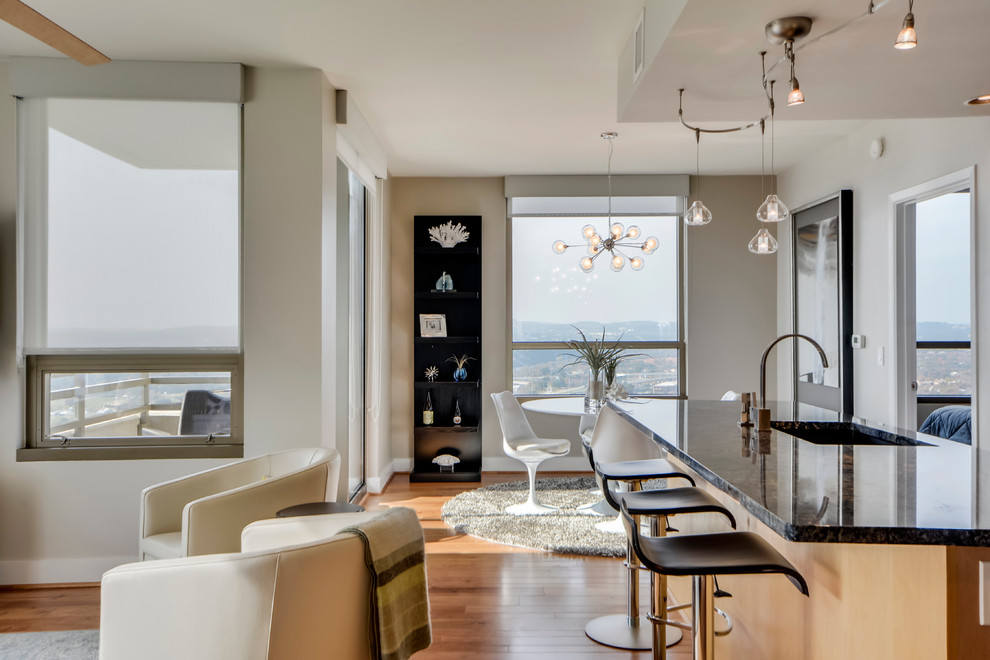 Example of a small transitional galley light wood floor open concept kitchen design in Austin with a double-bowl sink, flat-panel cabinets, light wood cabinets, granite countertops, gray backsplash, porcelain backsplash, stainless steel appliances and an island