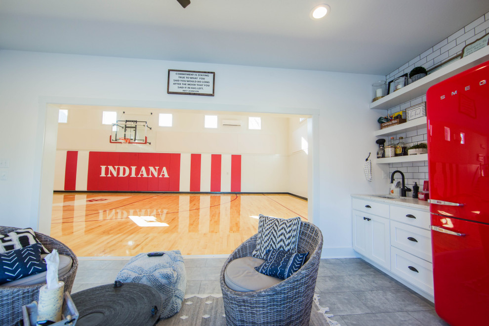 Photo of an expansive traditional indoor sport court in Indianapolis with white walls, painted wood floors, multi-coloured floor and vaulted.