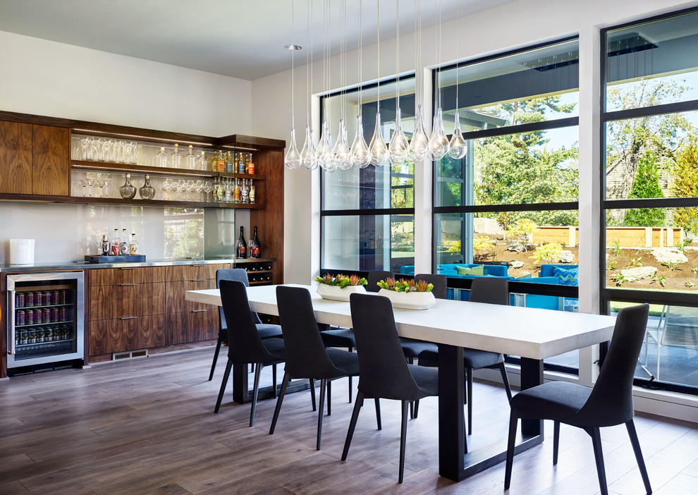 Inspiration for a contemporary dining room in Portland with white walls and dark hardwood floors.