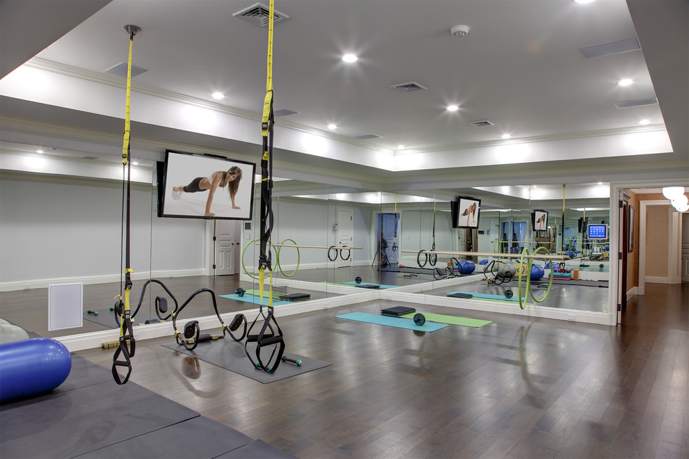 Large traditional multipurpose gym in Other with dark hardwood floors and brown floor.